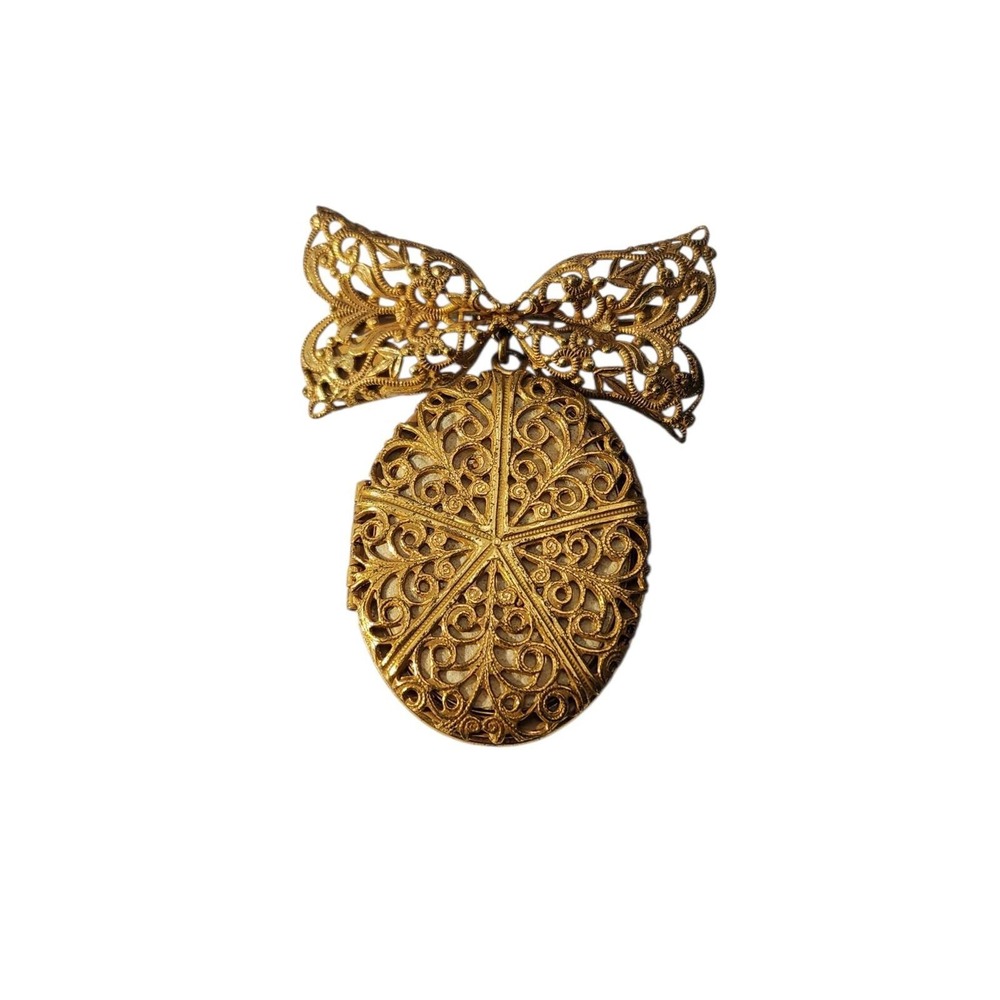 Vintage gold tone signed Miriam Haskell filigree locket on bow‎ brooch pin